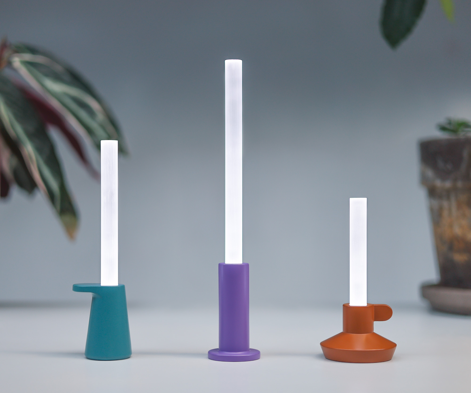 Photograph of the three digital candles on a white background.